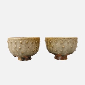 A pair of Chinese Sui Dynasty celadon drum-nail cups