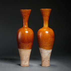 A pair of yellow-glazed long-necked vases from the Liao Dynasty, China