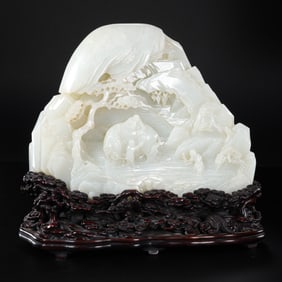A Chinese Qing Dynasty Hetian white jade carving in the shape of a mountain