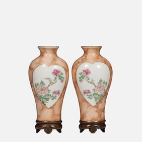 A pair of Chinese Qing dynasty famille rose vases with floral designs