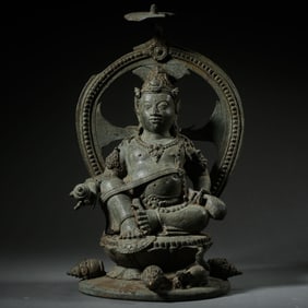A bronze statue of a seated Buddha from the 4th century AD, from the Kuishan Dynasty