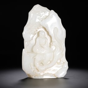 A 17th-18th century relief Hetian white jade figurine with a dragon-subduing Arhat