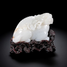 A Qing Dynasty Qianlong period red sandalwood base inlaid with Hetian white jade animal ornaments