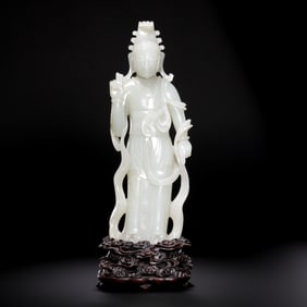 A 17th-18th century rosewood base with Hetian white jade standing figure of Guanyin