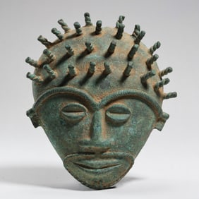 BRONZE MASK OF A DEITY FROM WESTERN ASIA, CIRCA 2000 AD