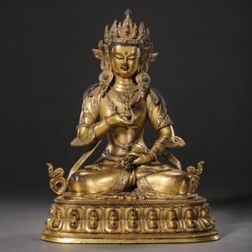 A CHINESE GILT-BRONZE STATUE OF A SEATED BUDDHA FROM THE QIANLONG PERIOD OF THE QING DYNASTY