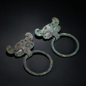 A PAIR OF BRONZE PAVING HEADS FROM THE CHINESE WARRING STATES PERIOD