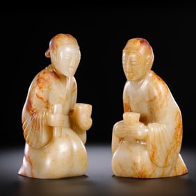 A PAIR OF CHINESE HAN DYNASTY HETIAN JADE KNEELING FIGURES