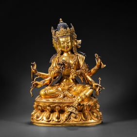A CHINESE GILT-BRONZE STATUE OF A SEATED BUDDHA FROM THE YONGLE PERIOD OF THE MING DYNASTY