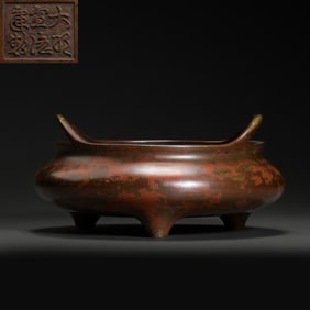 A BRONZE TRIPOD STOVE WITH TWO HANDLES FROM THE XUANDE PERIOD OF THE MING DYNASTY, CHINA