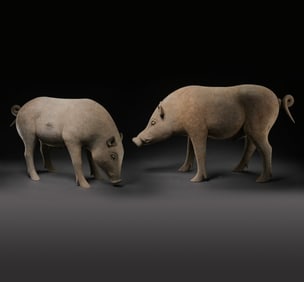 A PAIR OF CHINESE HAN DYNASTY POTTERY PIGS