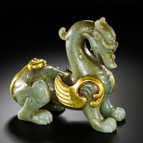 A Warring States Period Gilt and Turquoise-Inlaid Hetian Jade Mythical Beast, 4th–3rd Century BCE