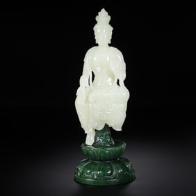 An 18th-century Chinese Qing Dynasty Hetian white jade Guanyin seated statue with a jasper base.