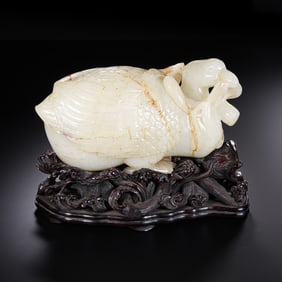 A 16th-century Chinese Ming Dynasty Hetian white jade quail ornament.
