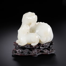 A 17th-century Chinese Qing Dynasty Hetian white jade sculpture of a lion and its young.