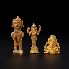 Around the 11th century, a set of three pure gold deity statues from Southeast Asia.