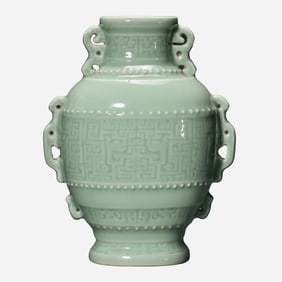 An 18th-century celadon-glazed vase with antique-style double handles from the Qing Dynasty, bearing