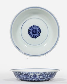 A 15th-century Chinese Ming dynasty blue and white porcelain plate with a scrolling floral design