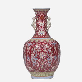 An 18th-century Chinese famille rose vase with openwork floral design and two handles, bearing the