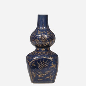 A 16th-century Chinese Ming Dynasty blue-ground gilt-decorated gourd-shaped vase with a round top