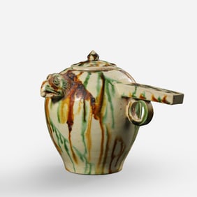 A sancai (three-color glazed) jar with a dragon handle and lid from the Tang Dynasty in the 8th