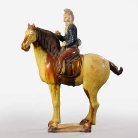 A tricolor camel statue of a Central Asian man from the Tang Dynasty (7th-8th centuries AD).