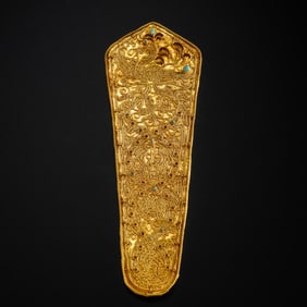 A pure gold dangling ornament inlaid with turquoise from the Tang Dynasty in China, dating from the