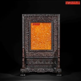 An 18th-century Chinese Qing Dynasty zitan wood carved screen with a sea dragon design and inlaid