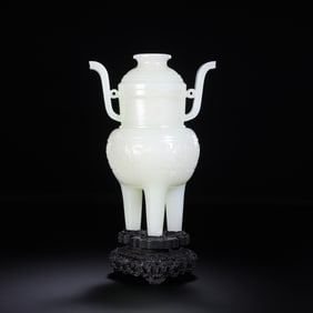 An 18th-century Chinese Qing Dynasty Hetian white jade antique-style cloud-patterned tripod censer.