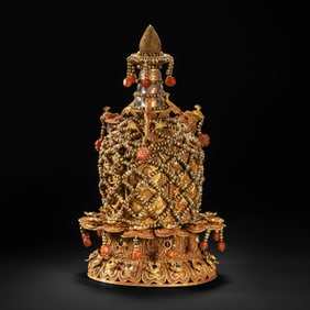A multi-tiered, pure gold stupa inlaid with gemstones, dating from the Ming Dynasty (15th-16th