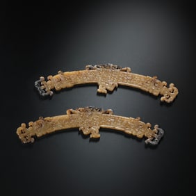 A pair of Chinese Han Dynasty Hetian white jade dragon-patterned pendants from the 1st-2nd century