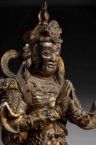 A seated bronze gilt-bronze Heavenly King statue from the Ming Dynasty in China, dating back to the