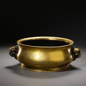 A 15th-century gilt bronze incense burner with lion-shaped handles from the Ming Dynasty in China.