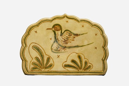 A brown-green painted pillow with floral and bird patterns from the Changsha kiln during the Tang