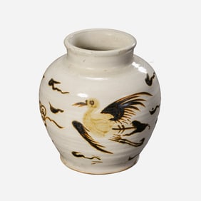 A Cizhou ware jar with white glaze and black floral phoenix design, dating from the Yuan Dynasty
