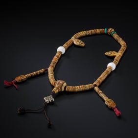 AN IMPORTANT AND HIGHLY DECORATED INLAID 'KAPALA' (HUMAN SKULL) ROSARY,MALATIBET (LHASA REGION),