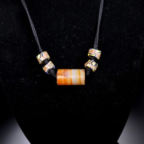 A RARE HIMALAYAN ORANGE AND WHITE BANDED AGATE NECKLACEHIMALAYAN REGION, ANCIENT TO MEDIEVAL PERIOD