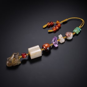 A RARE AND HIGHLY CURATED COMPOSITE GROUP OF ARCHAIC JADE AND PRECIOUS HARDSTONE PENDANTSRANGING