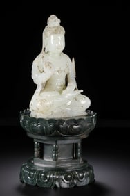 A MONUMENTAL AND RARE JADE FIGURE OF SEATED GUANYIN ON A SPINACH-GREEN JADE LOTUS BASEMING DYNASTY