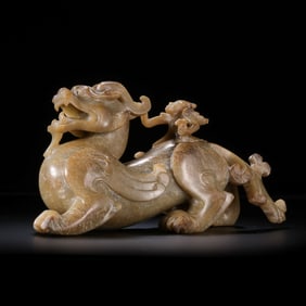 A MONUMENTAL AND EXCEPTIONALLY RARE WHITE JADE GROUP OF AN IMMORTAL RIDING A WINGED MYTHICAL