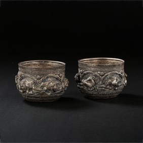 A RARE AND MAGNIFICENT PAIR OF REPOUSSÉ SILVER 'TIGER AND DEER' CUPSTANG DYNASTY (618–907 AD)