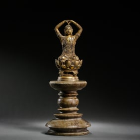 A RARE GILT-BRONZE FIGURE OF A SEATED BUDDHA ON A TIERED STONE PEDESTALLIAO DYNASTY (907-1125)