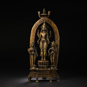 A MAGNIFICENT COPPER ALLOY TRIAD OF A FOUR-ARMED DEITY AND ATTENDANTSCENTRAL TIBET OR NEPAL,