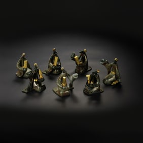 A RARE AND MAGNIFICENT SET OF SEVEN GOLD-INLAID GREEN JADE FIGURES OF MUSICIANSWARRING STATES PERIOD