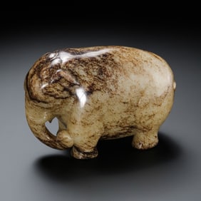 A RARE AND MONUMENTAL ARCHAIC WHITE JADE FIGURE OF AN ELEPHANTHAN DYNASTY (206 BC – 220 AD)