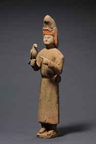 A RARE AND VIVIDLY PAINTED POTTERY FIGURE OF A FOREIGN FALCONERTANG DYNASTY (618–907 AD)