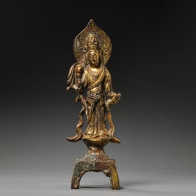 A RARE AND FINELY CAST GILT-BRONZE FIGURE OF A STANDING GUANYINNORTHERN WEI DYNASTY (386-534 AD),