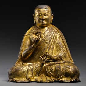 RARE AND MAGNIFICENT GILT-BRONZE FIGURE OF A SEATED LAMATIBET OR NEPAL, 15TH - 16TH CENTURY