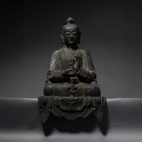 A RARE AND SPIRITED BRONZE FIGURE OF A SEATED TAOIST CELESTIAL MASTER OR IMMORTALMING DYNASTY