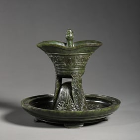 A RARE AND MAGNIFICENT SPINACH-GREEN JADE 'ARCHAISTIC' LIBATION CUP AND STANDMING - QING DYNASTY